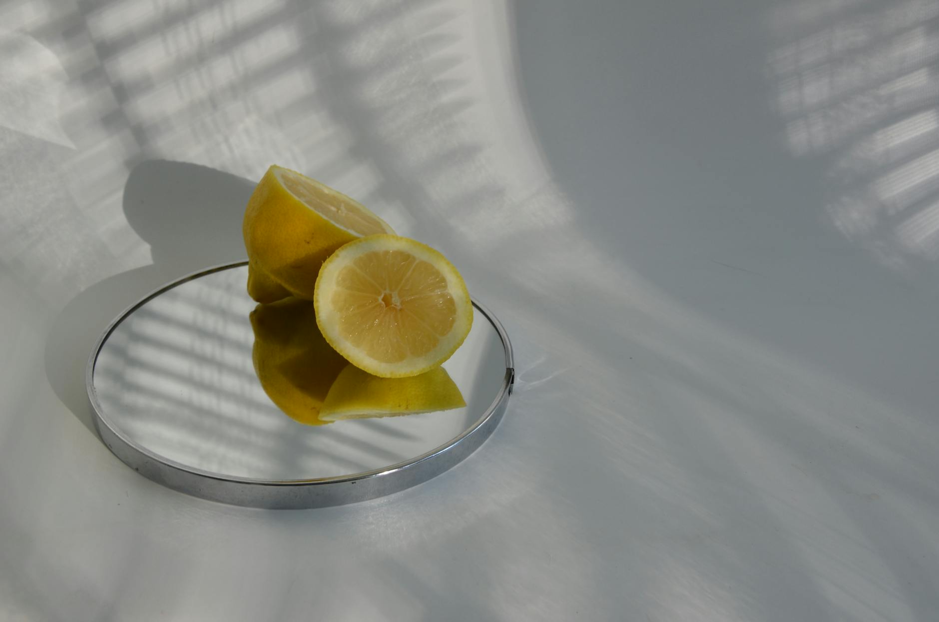Bright ripe lemons on a pastel yellow background, evoking fresh discovery and intimacy