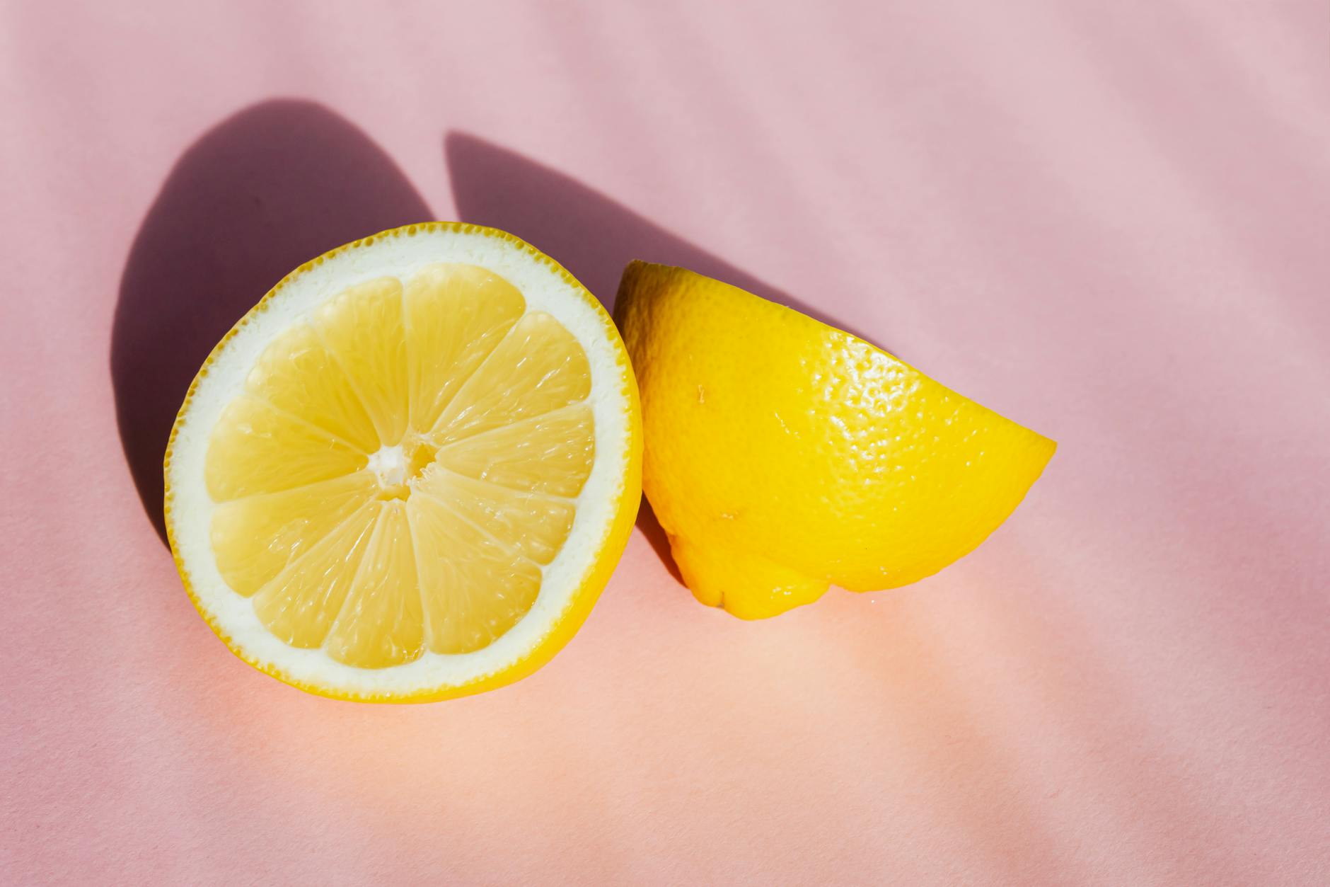 Two women smiling while holding lemon slices, expressing joy and comfort