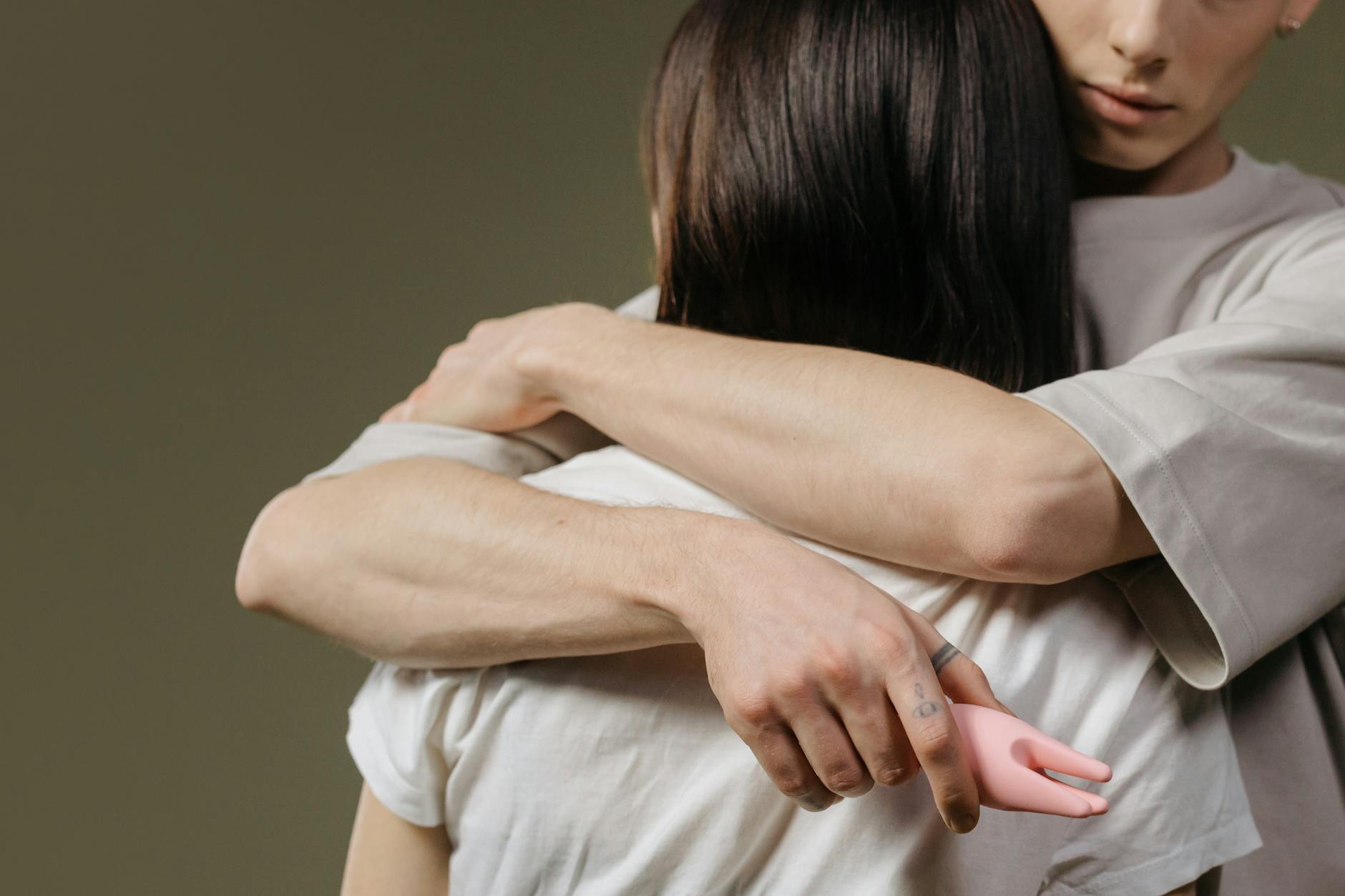 Close-up of a couple embracing with tenderness and care, highlighting emotional intimacy and connection.